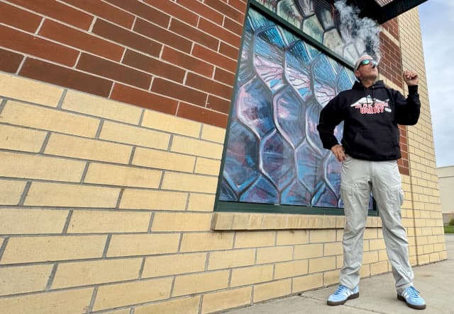 Rich in front of Delong with FHW hoodie and cigar